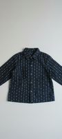 Navy blue shirt with white pattern on a light gray background