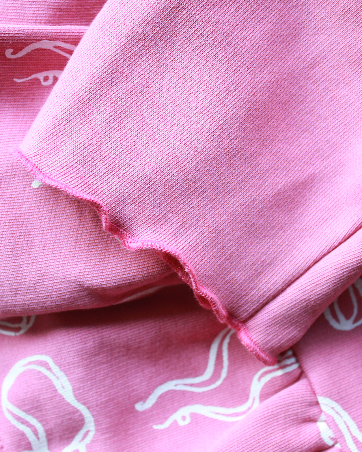 Close-up of pink fabric with white bow patterns
