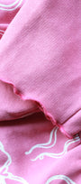 Close-up of pink fabric with white bow patterns