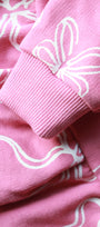 Close-up of pink fabric with white floral patterns