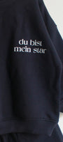 BLUE sweatshirt with white text 'du bist mein star' on a white background