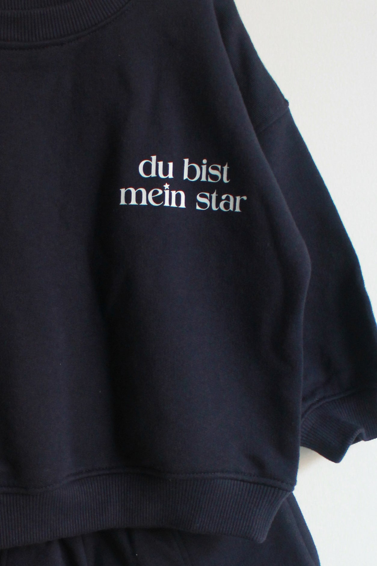 BLUE sweatshirt with white text 'du bist mein star' on a white background