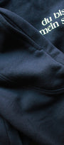 Navy blue sweatshirt with white text 'du bist mein Star' on a dark background