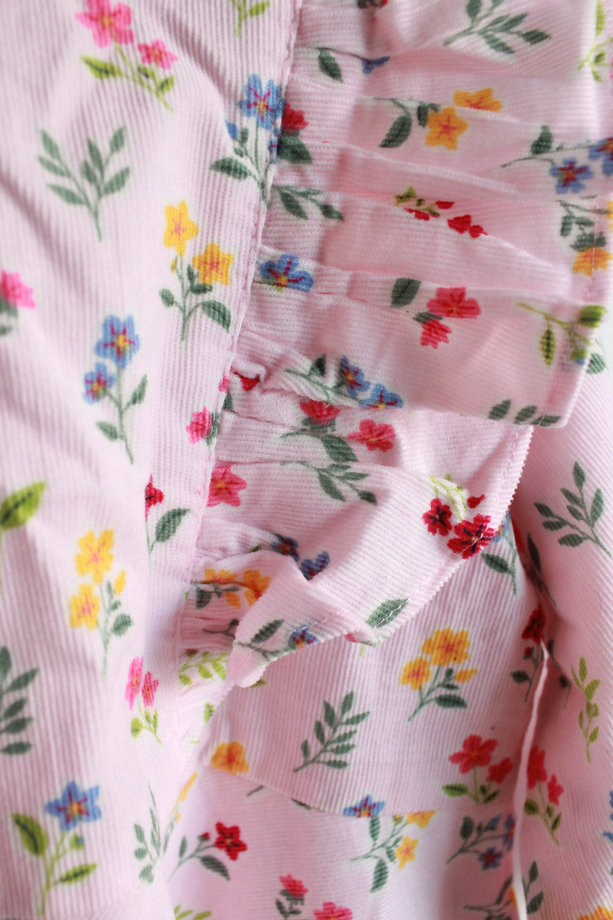 Close-up of a floral patterned fabric with pink background